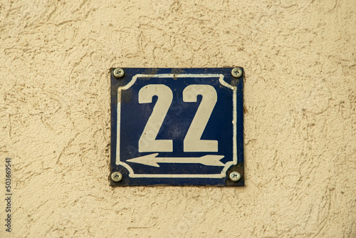 Weathered grunge square metal enamelled plate of number of street address with number 22