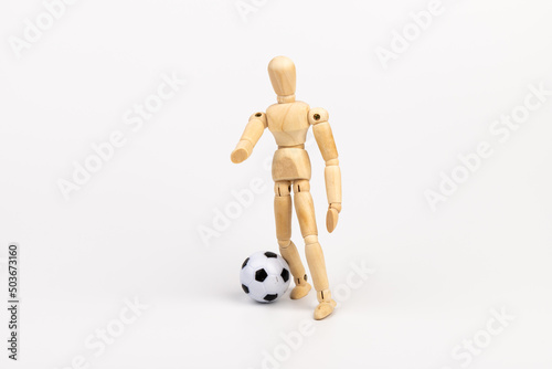 Wooden mannequin with soccer ball isolated on white background. Football player concept.