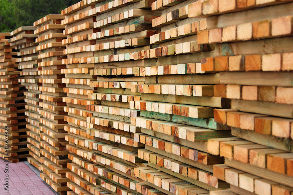 Stacks of wooden planks and boards. Timber and lumber, woodworking background Stacks of wooden planks and boards. Timber and lumber, woodworking background