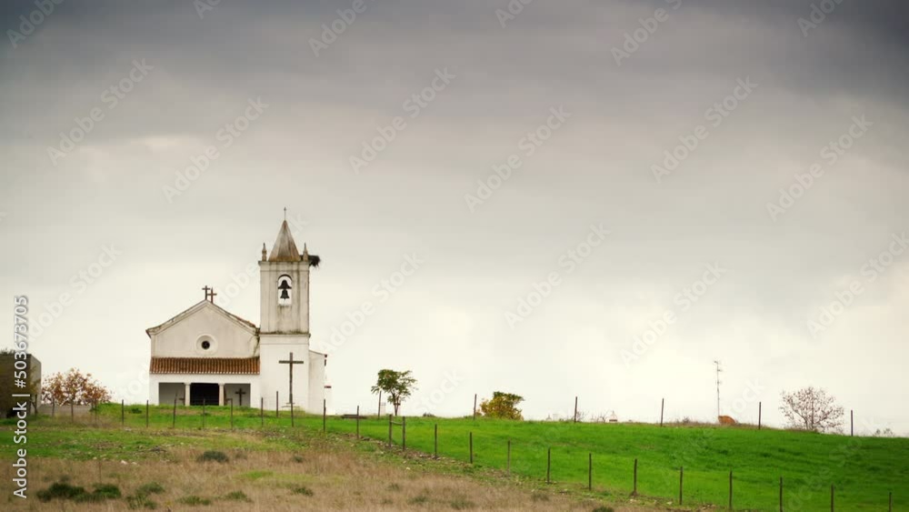 Time lapse of rainy stormy clouds moving over small church in village Luz in the district of Evora, Portugal. Time lapse of rainy stormy clouds moving over small church in village Luz in the district of Evora, Portugal.