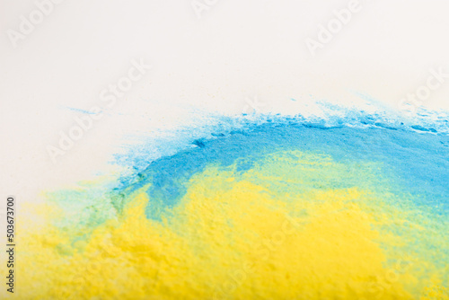 Ukrainian flag colours. The concept of war in Ukraine. Blue and yellow background from holi powder paint.