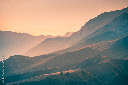Beautiful mountains at sunset. Autumn landscape, nature background. Ingushetia, North Caucasus, Russia. © smallredgirl