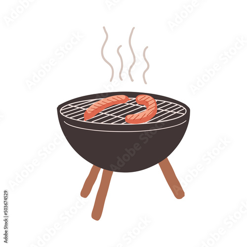 The black grill stands on legs. Sausages are fried on the grill