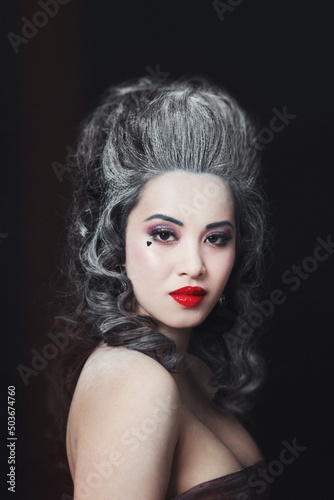 Vintage style portrait of young beautiful asian woman with red lipstick