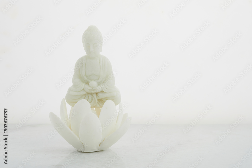 Vesak, Wesak, Buddha birthday. Buddha statue with lotus on white background. Spa ritual. Mental health and meditation. Vesak, Wesak, Buddha birthday. Buddha statue with lotus on white background. Spa ritual. Mental health and meditation.