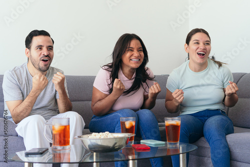 Friends together watching sports on TV at home