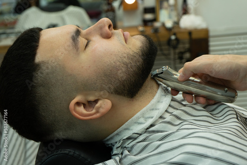 barber shaves his client