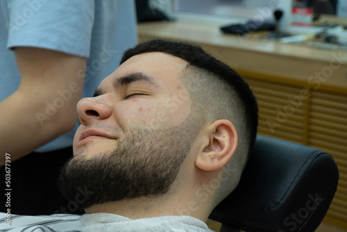 client lies happy in barber's chair