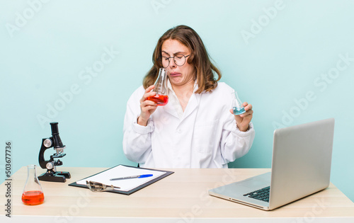 young physician woman with a microscophe. sciencist concept photo