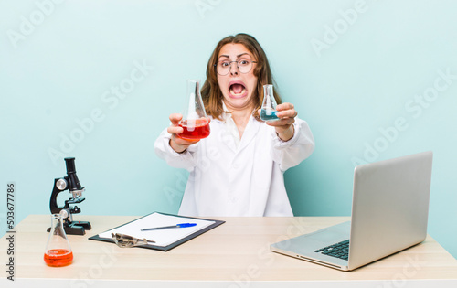 young physician woman with a microscophe. sciencist concept photo