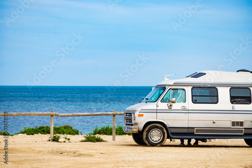 American van on beach seashore. Holidays trip.