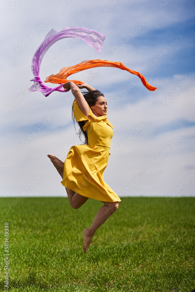 Young woman jumping for joy on a wheat field Young woman jumping for joy on a wheat field