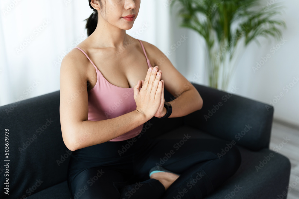 stress relief, muscle relaxation, breathing exercises, exercise, meditation, portrait of Young Asian woman relaxing her body from office work by practicing yoga by watching online tutorials. stress relief, muscle relaxation, breathing exercises, exercise, meditation, portrait of Young Asian woman relaxing her body from office work by practicing yoga by watching online tutorials.