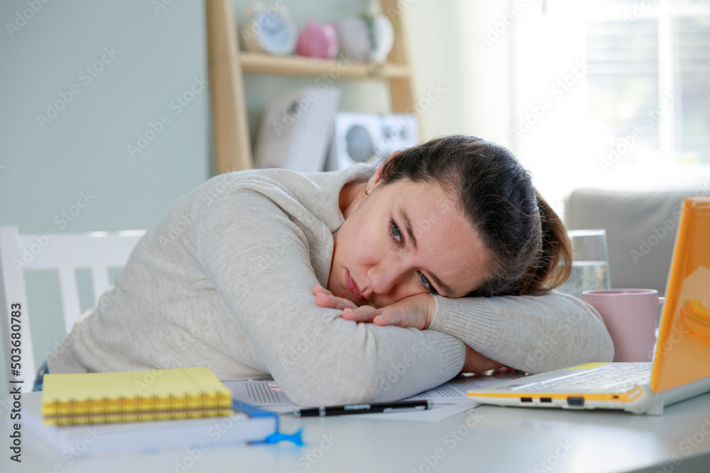 Tired business woman in the home office with laptop Tired business woman in the home office with laptop