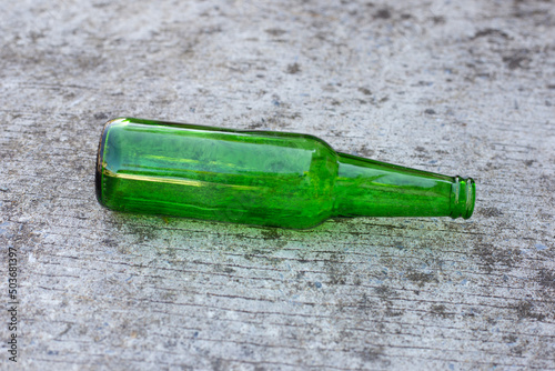 Green bottle on cement floor