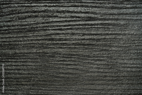 Dark gray wood texture, horizontal. Black background.