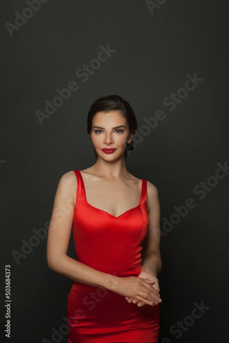 Gorgeous elegant brunette woman wearing fashion red dress