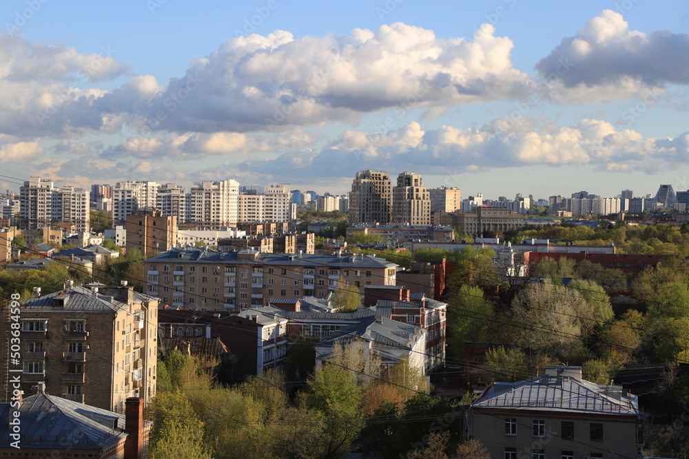 Panorama of the southern administrative district of the city of Moscow on a spring sunny day with expressive clouds in the blue sky.