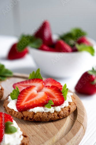 Homemade strawberry tart with oat biscuit and whipped cream. Recipe of fast berry cake for breakfast or holiday. Summer light dessert.