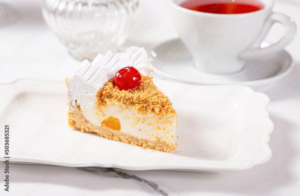 A piece of dessert on a white plate on a white marble table A piece of dessert on a white plate on a white marble table