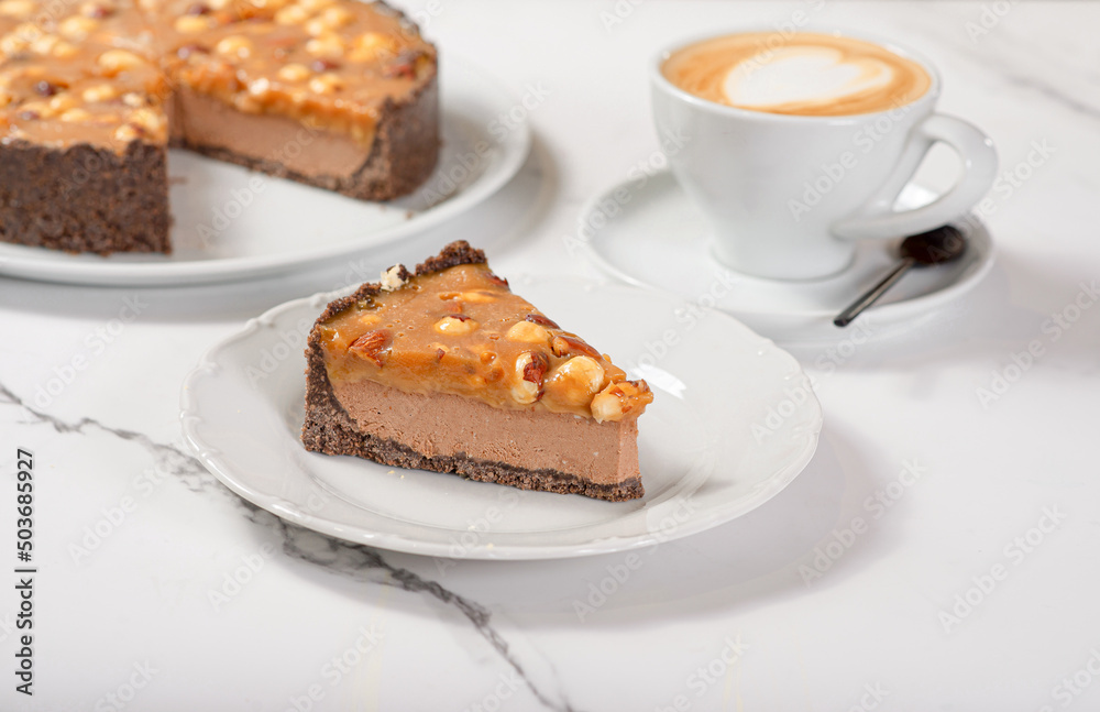 Fresh dessert on a white plate among white dishes with tea and coffee in a cafe Fresh dessert on a white plate among white dishes with tea and coffee in a cafe