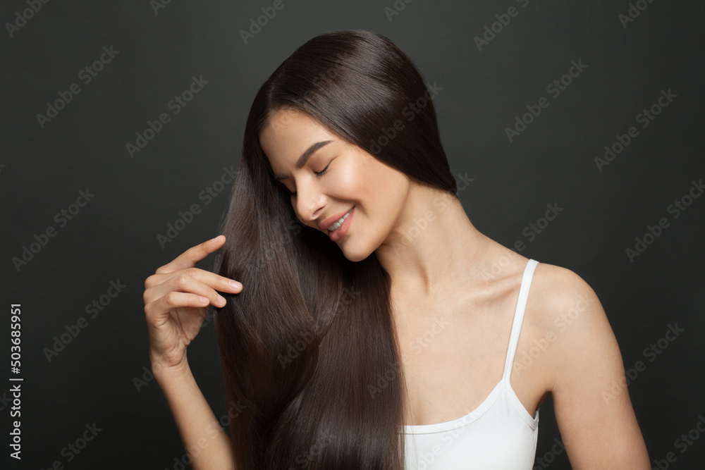 Portrait of a beautiful woman with long hair. Young brunette model with beautiful hairstyle