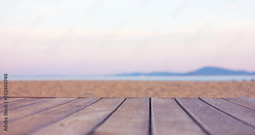 wooden flooring from brown boards on a sandy beach near the sea
