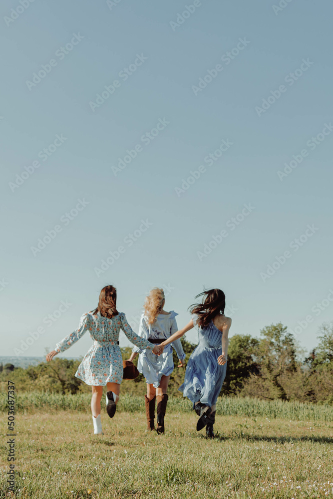 Girls holding their hands. View from from below. Girls holding their hands. View from from below.