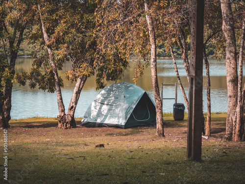 Tent near the lakeside in the forest surrounded by trees in Teresopolis photo