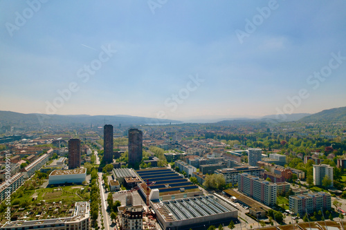 Aerial view of City of Zürich on a sunny spring day with blue cloudy sky background. Photo taken April 28th, 2022, Zurich, Switzerland. © Michael Derrer Fuchs