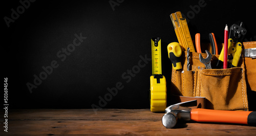 home improvement - construction tools on black background with copy space. banner photo