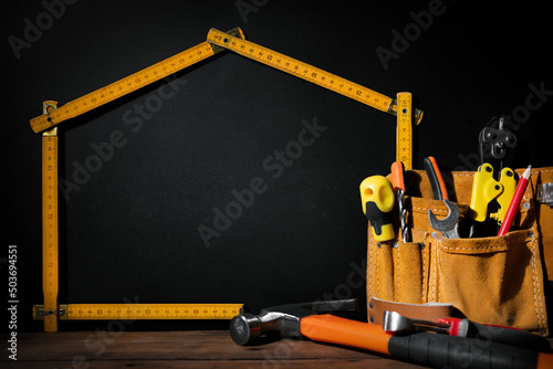 home improvement and repair. construction tools on black background with copy space photo