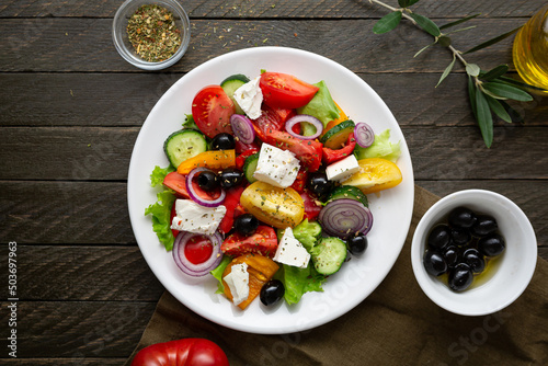 Overhead view of Greek salad on wooden background