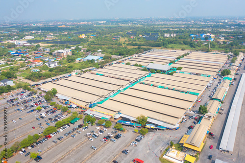 Aerial top view of Sanam Luang street market , green roof tops, horse shoe shape drive thru and parking area. Tents with retail shops. photo