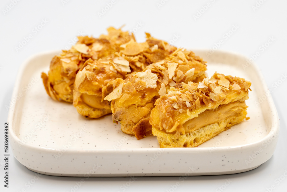 Cream eclairs cake. Eclair cake with cream filling on a white background. close up Cream eclairs cake. Eclair cake with cream filling on a white background. close up