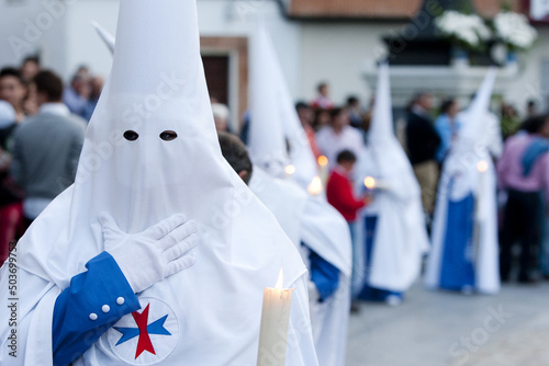 Person with a white, traditional capirote at the Spanish Holy Week procession photo