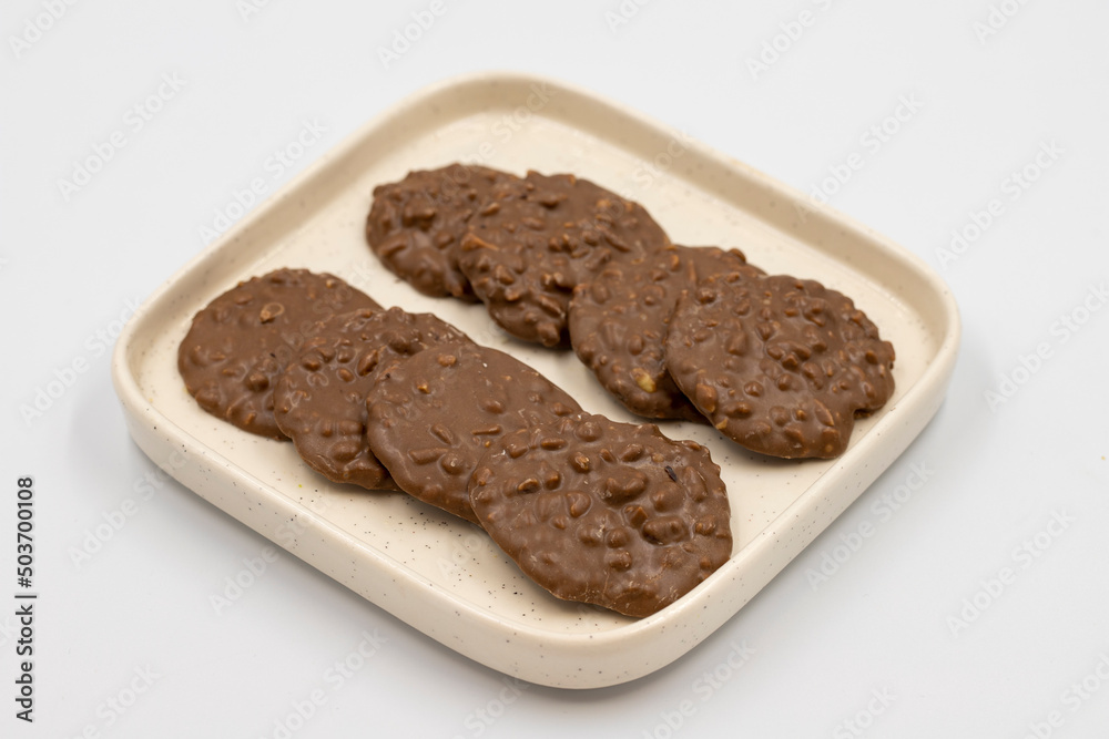 Special chocolate with hazelnut particles. Chocolate with hazelnuts on a white background. close up Special chocolate with hazelnut particles. Chocolate with hazelnuts on a white background. close up
