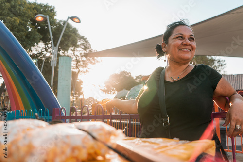 Itinerant fruit vendor in a park in Managua Nicaragua smiling at sunset. Concept of self-employment photo