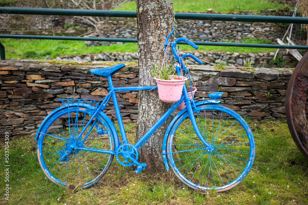 blue decorative bicycle on the street of village