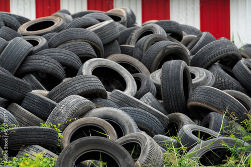 Pile of used tires. Old tyres waste for recycle or for landfill. Black rubber tire of car. Pile of used tires at recycling manufacturing yard. Material for landfill. Pile of second hand tires for sale photo