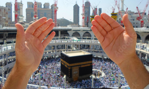 Muslims raise their hands to pray at the Kaaba photo