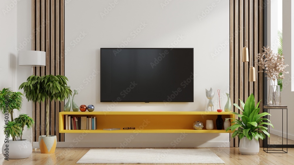 Fototapeta Yellow shelf and TV in modern living room have empty white wall background.