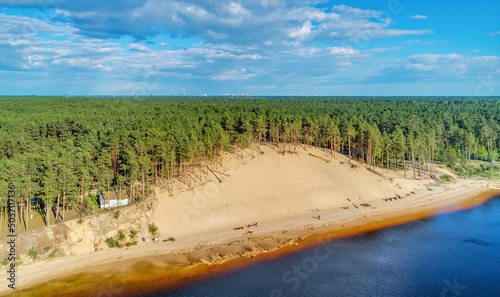 Aerial view of White dune near the Lielupe river covered with pine forest with a blue sky in Latvia photo