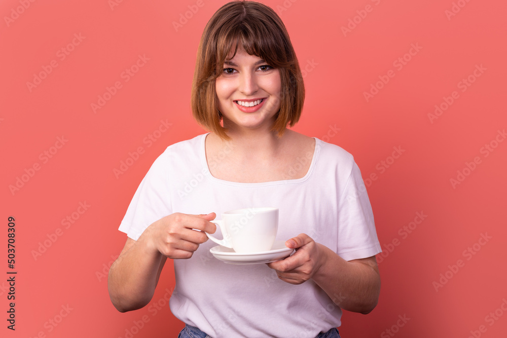 Photo of cheerful lady hold aromatic cup of coffee smell flavor wear white t shirt isolated pastel pink color background Photo of cheerful lady hold aromatic cup of coffee smell flavor wear white t shirt isolated pastel pink color background