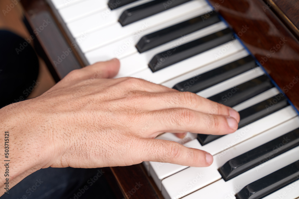 Unrecognizable male musician playing piano Unrecognizable male musician playing piano
