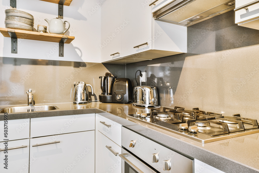Contemporary kitchen with chrome built in appliances and white cabinets Contemporary kitchen with chrome built in appliances and white cabinets