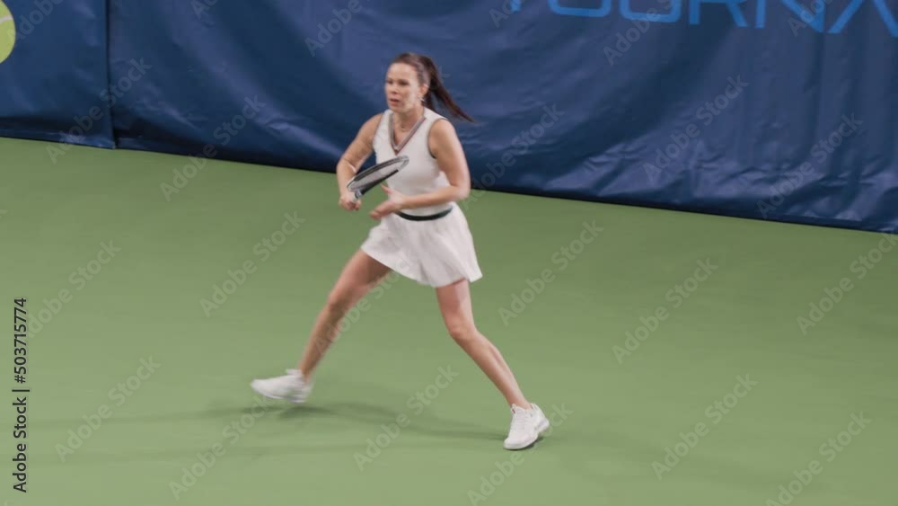 Sports TV Female Tennis Match on Championship. Female Tennis Player Hitting Ball with a racquet, Playing Professionally on Tournament. Live Network Channel Television. 50 FPS Playback Wide Shot Sports TV Female Tennis Match on Championship. Female Tennis Player Hitting Ball with a racquet, Playing Professionally on Tournament. Live Network Channel Television. 50 FPS Playback Wide Shot