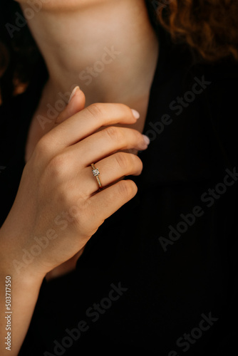 Golden Ring on a female hand, diamonds Diamond ring in hands of young lady. Close-up photo shoot