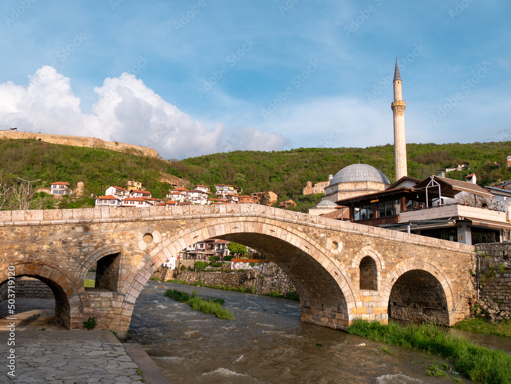 Old Ottoman bridge and mosque in Prizren, Kosovo just before sunset