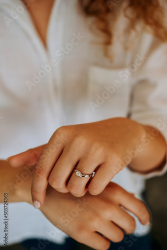 Golden Ring on a female hand, diamonds Diamond ring in hands of young lady. Close-up photo shoot